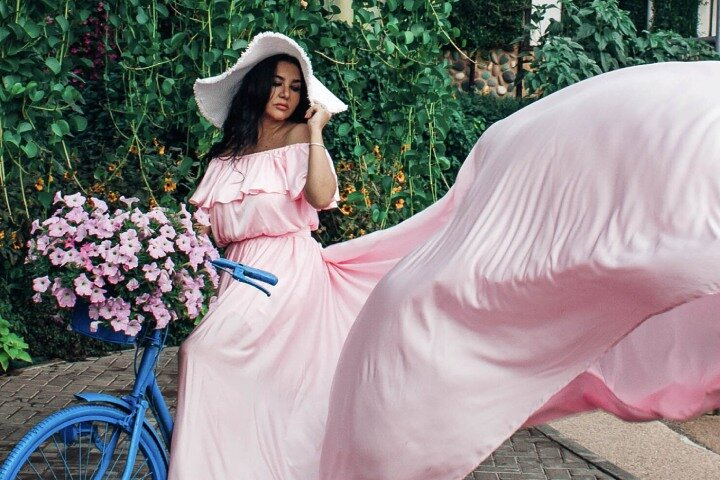 Experience the beauty of Dubai's Miracle Garden striking a pose in a flowing dress as the desert breeze adds a touch of elegance to your unforgettable photoshoot.